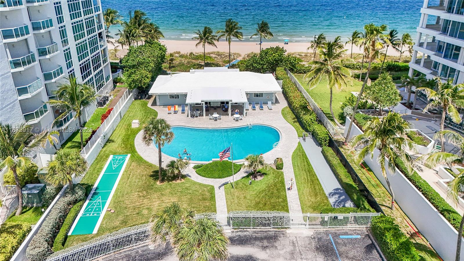 1431 South Ocean Boulevard, Unit 11 Lauderdale-by-the-Sea, FL 33062 - Photo 3 of 42 a view of a swimming pool with a patio
