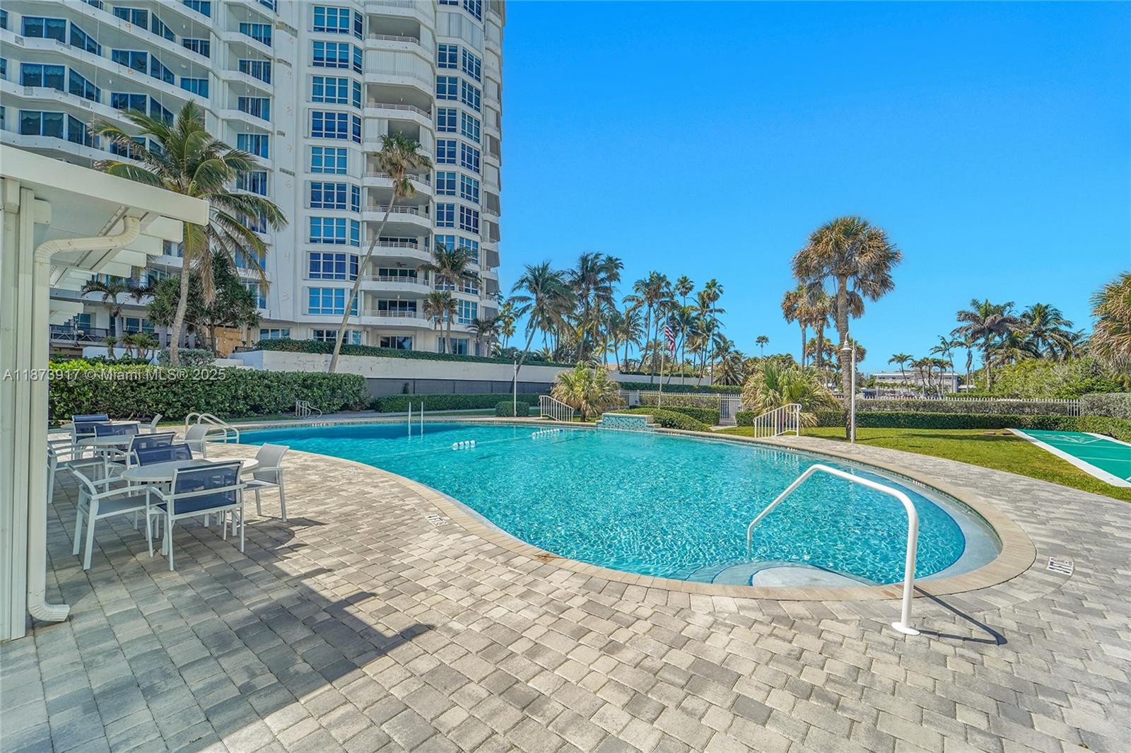 1431 South Ocean Boulevard, Unit 11 Lauderdale-by-the-Sea, FL 33062 - Photo 40 of 42 a view of a swimming pool with a lounge chair