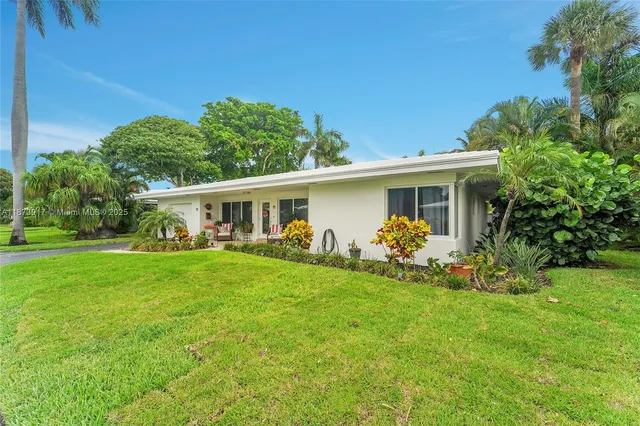 a front view of house with a garden