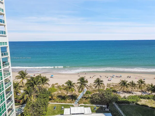 a view of a large body of water with a building in the background