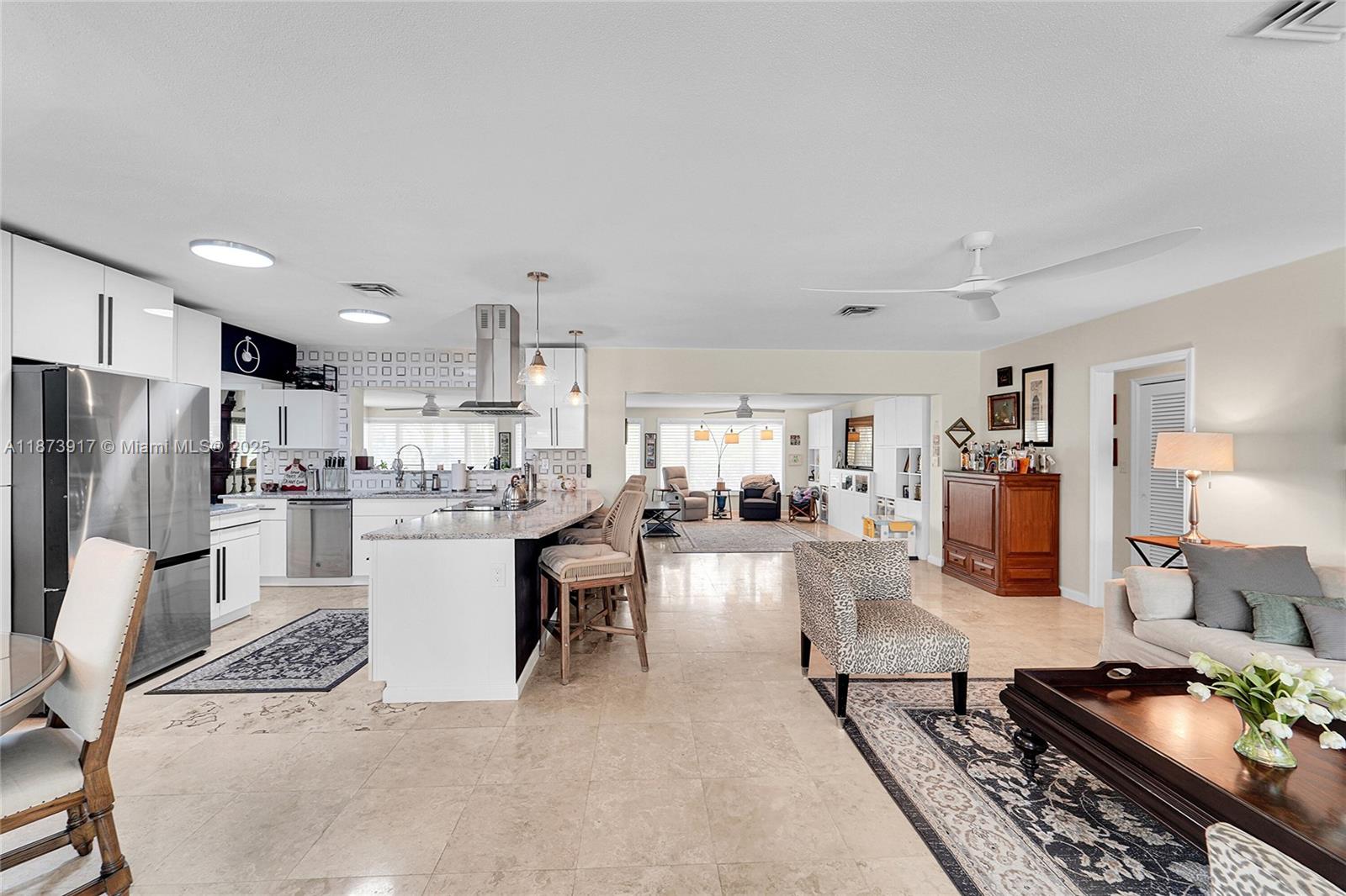 1431 South Ocean Boulevard, Unit 11 Lauderdale-by-the-Sea, FL 33062 - Photo 6 of 42 a kitchen with stainless steel appliances kitchen island granite countertop a stove refrigerator and cabinets