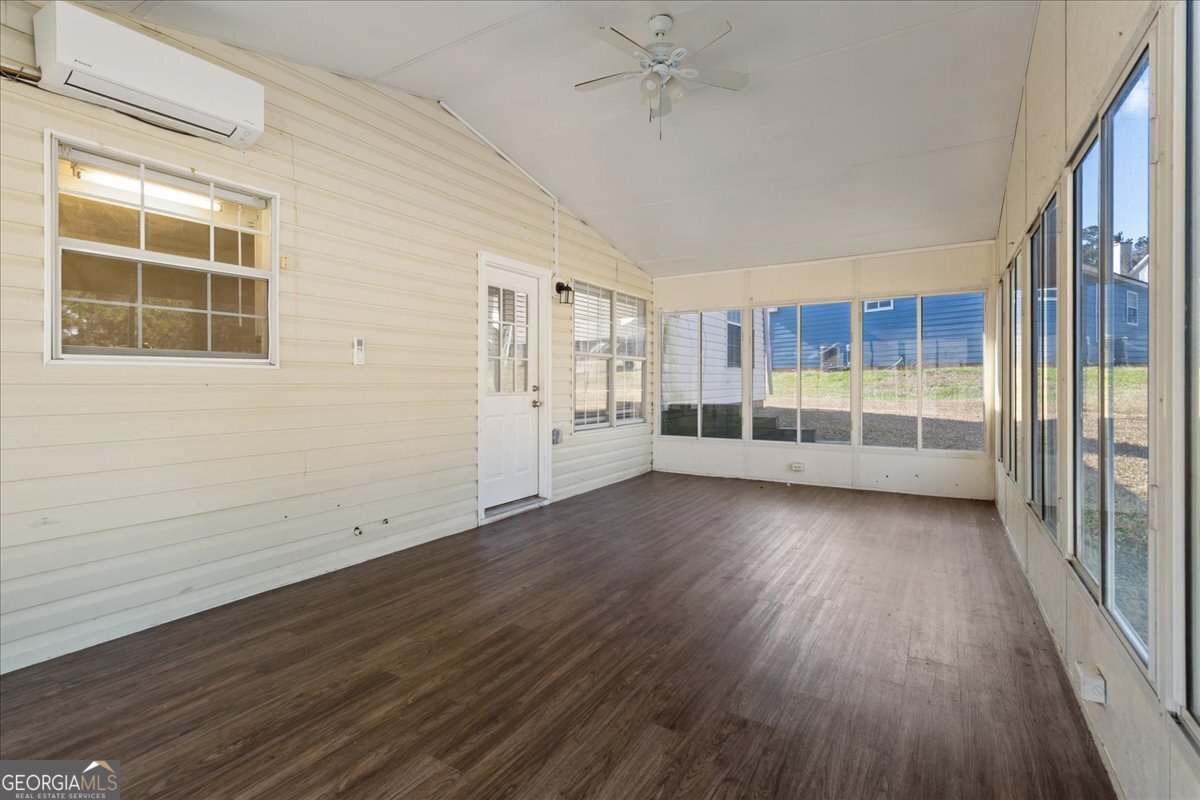 7132 New Dale Road Rex, GA 30273 - Photo 16 of 31 a view of wooden floor and windows in a room