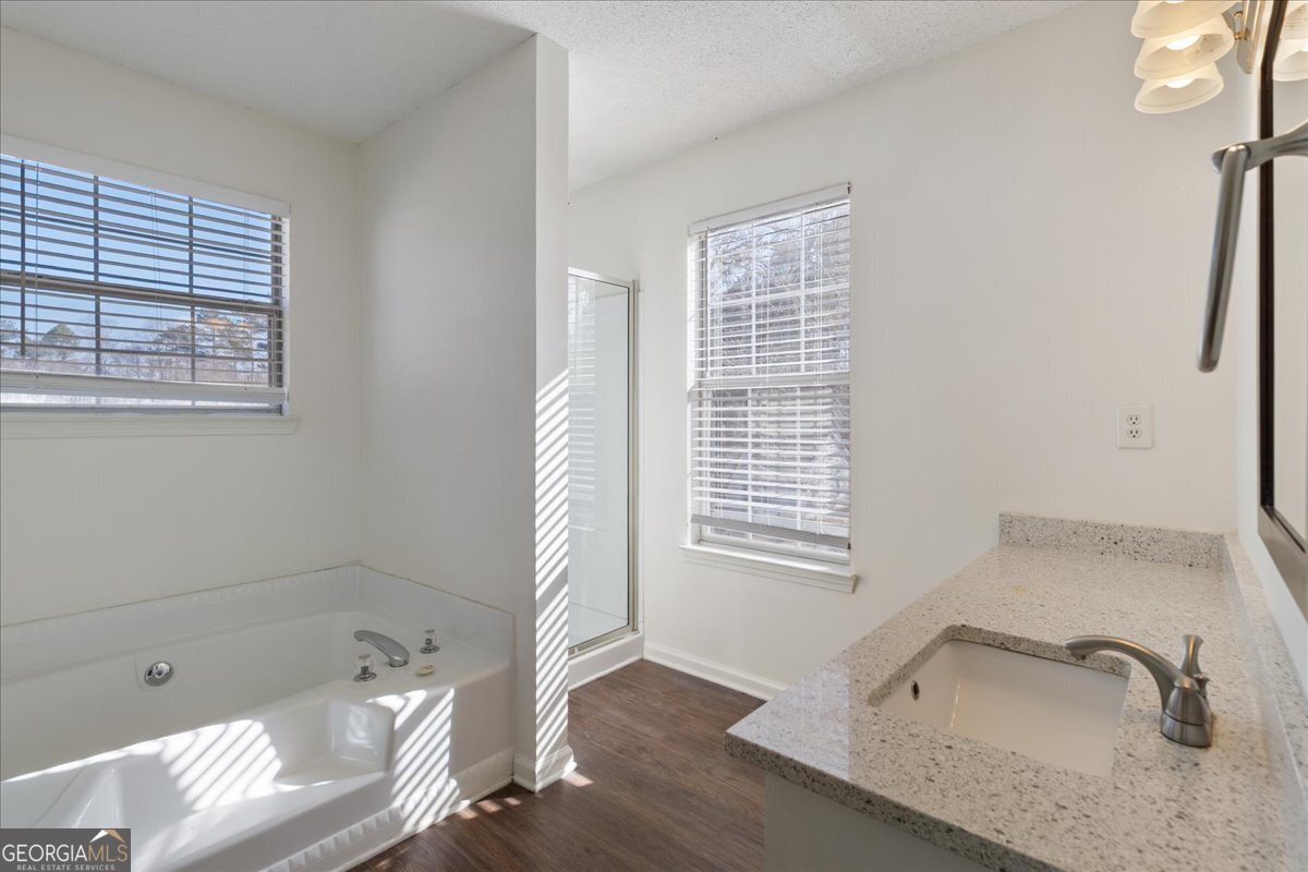 7132 New Dale Road Rex, GA 30273 - Photo 19 of 31 a bathroom with a tub sink and a window