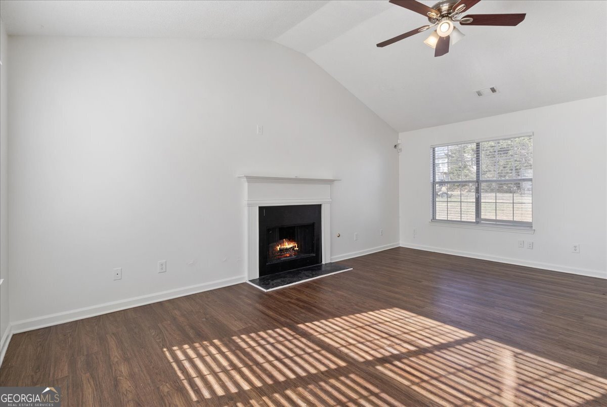 7132 New Dale Road Rex, GA 30273 - Photo 5 of 31 an empty room with windows a fireplace