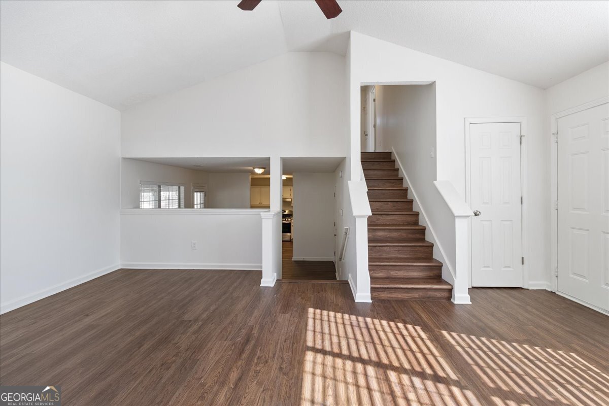 7132 New Dale Road Rex, GA 30273 - Photo 8 of 31 a view of a hallway with wooden floor and staircase