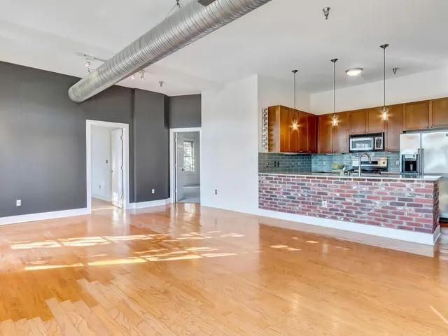 a view of a kitchen with a sink and cabinets