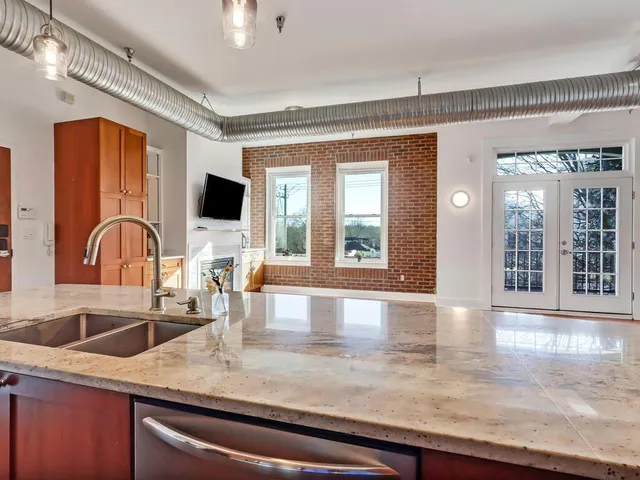 a kitchen with a sink and a wooden floor