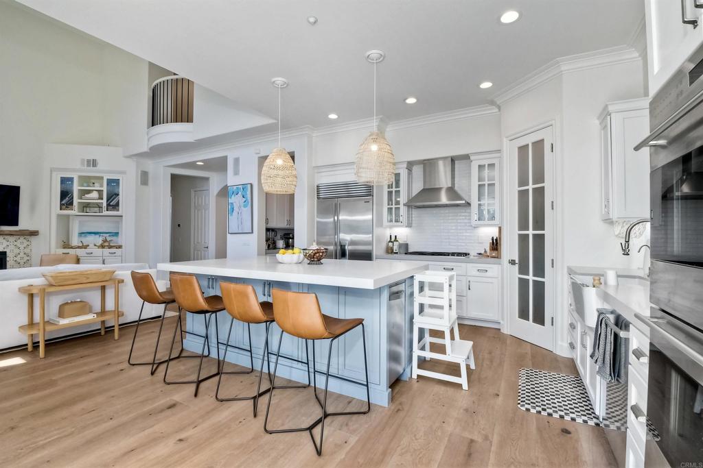 1475 Heritage Lane Encinitas, CA 92024 - Photo 23 of 28 a large kitchen with stainless steel appliances kitchen island granite countertop a large island in the center