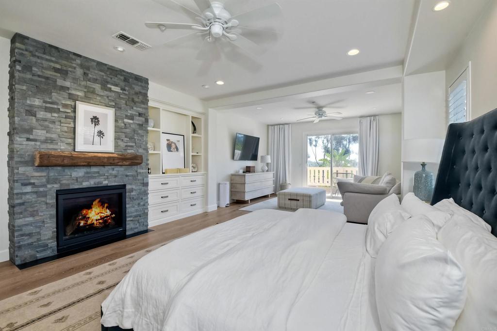 1475 Heritage Lane Encinitas, CA 92024 - Photo 10 of 28 a large bedroom with a bed and a fireplace