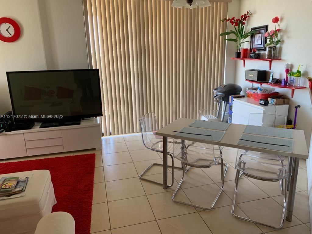 2301 Southwest 27th Avenue, Unit 1200 Miami, FL 33145 - Photo 2 of 9 a living room with furniture and a flat screen tv