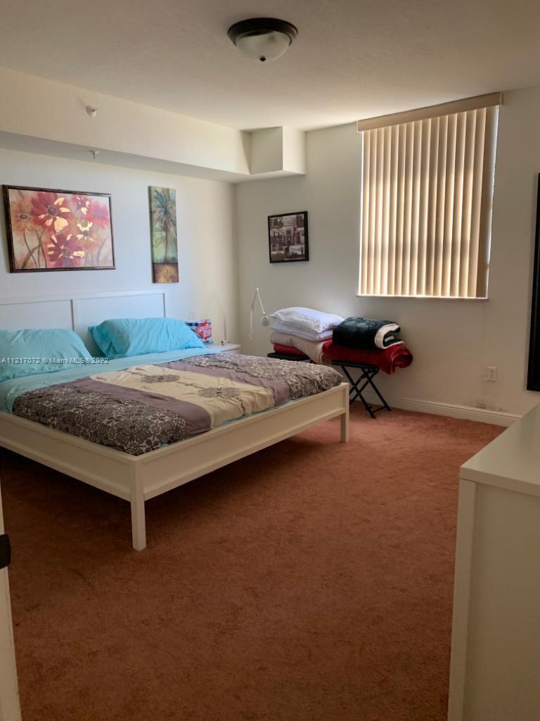 2301 Southwest 27th Avenue, Unit 1200 Miami, FL 33145 - Photo 3 of 9 a bed room with a bed and a couch