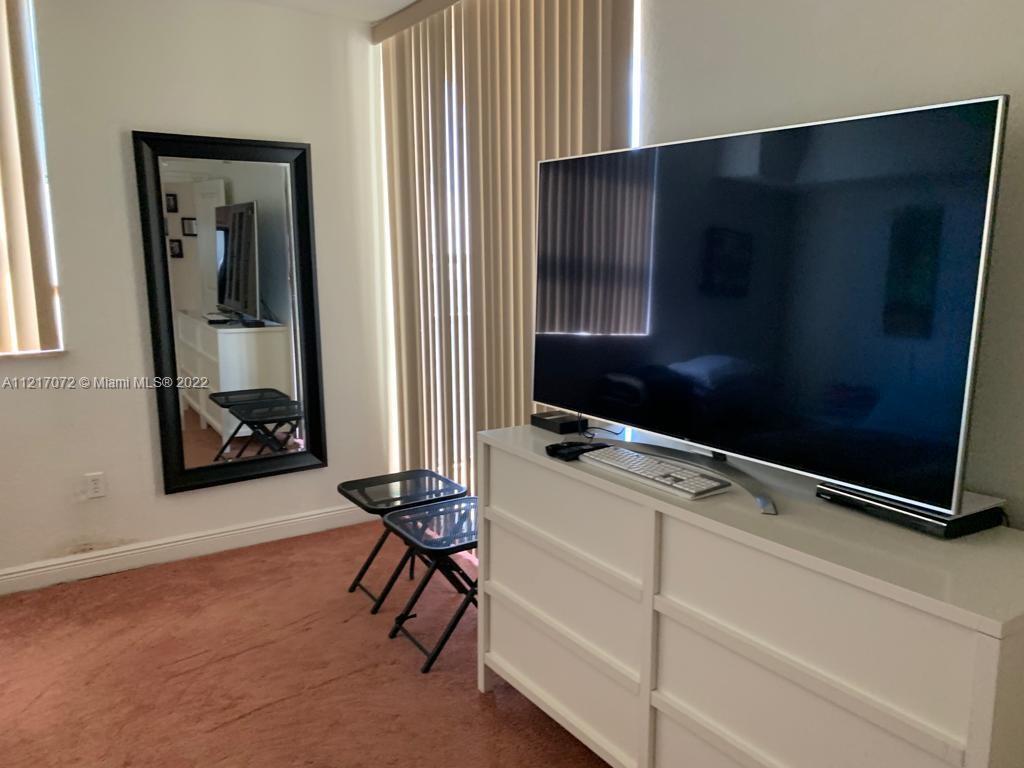 2301 Southwest 27th Avenue, Unit 1200 Miami, FL 33145 - Photo 5 of 9 a room with a walk in closet and mirror