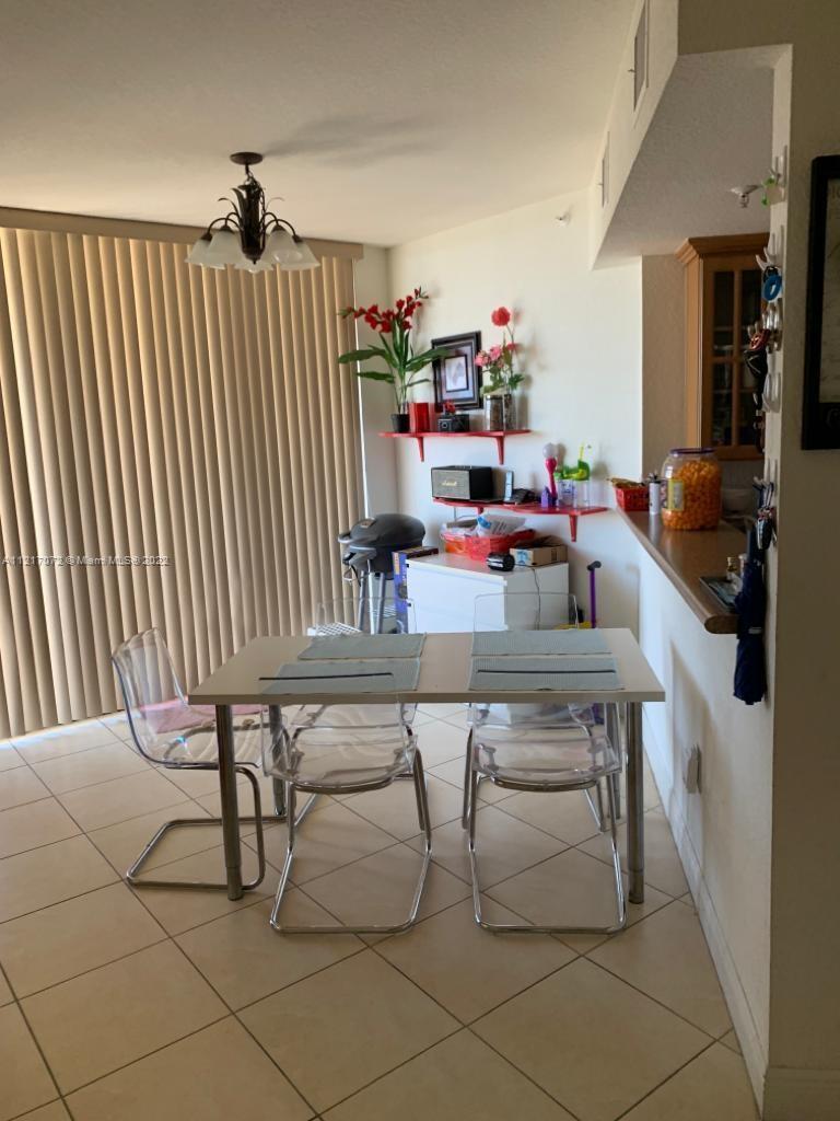 2301 Southwest 27th Avenue, Unit 1200 Miami, FL 33145 - Photo 6 of 9 a hallway with a table and a couch