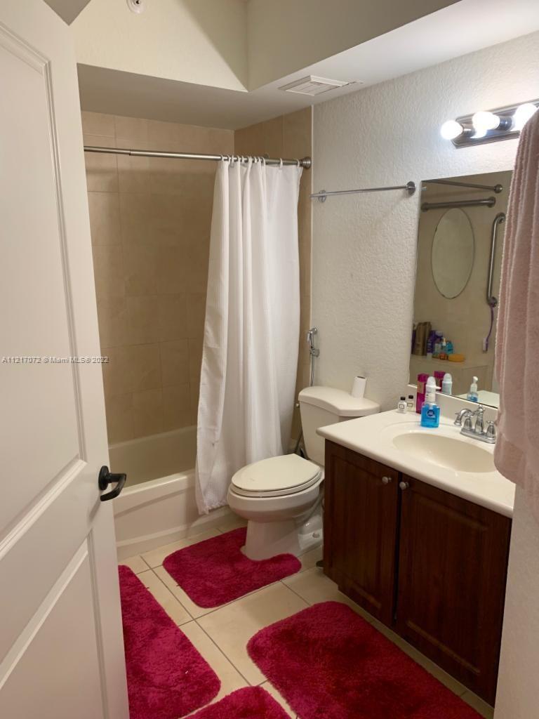 2301 Southwest 27th Avenue, Unit 1200 Miami, FL 33145 - Photo 7 of 9 a bathroom with a sink a toilet and shower