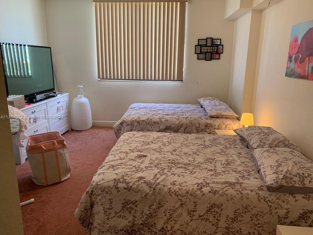 2301 Southwest 27th Avenue, Unit 1200 Miami, FL 33145 - Photo 8 of 9 a bedroom with a bed and window
