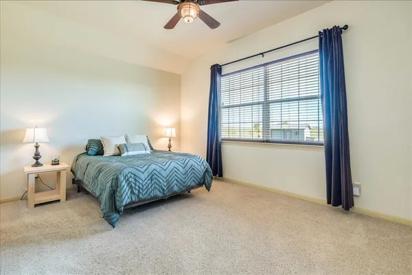 a spacious bedroom with a bed and a window