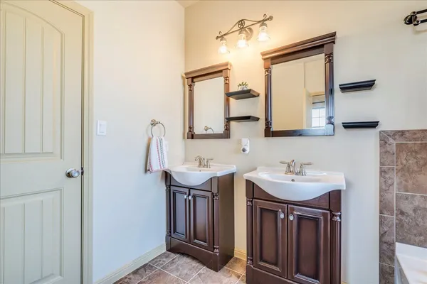 a bathroom with 2 sink and a mirror
