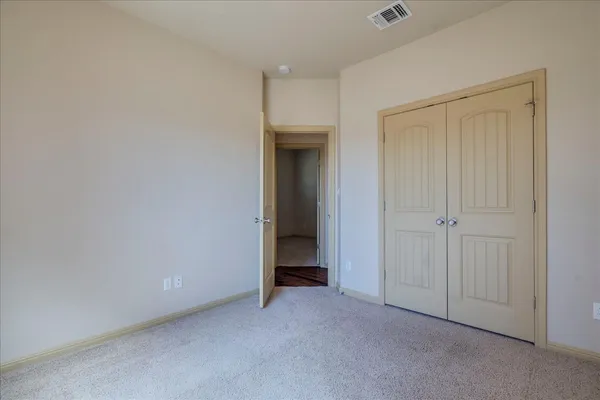 a view of an empty room and closet