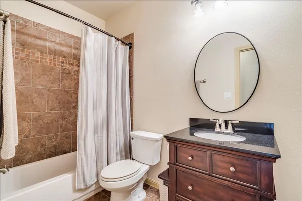 a bathroom with a sink a mirror a toilet and a bathtub