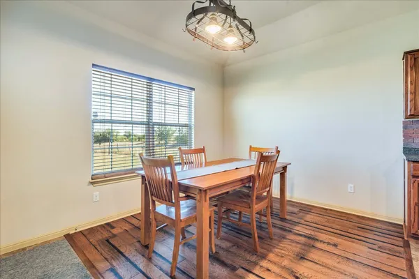 a view of a dining room with furniture wooden floor and chandelier