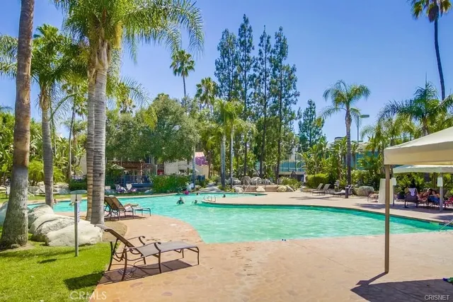 a view of a park with bench and trees