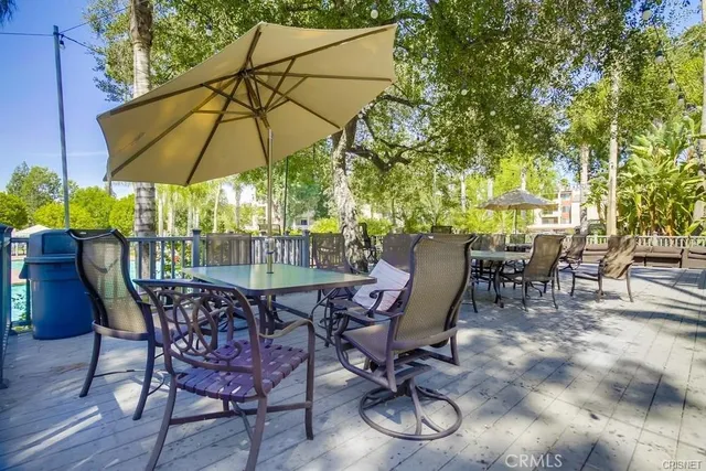 a view of a backyard with table and chairs under an umbrella