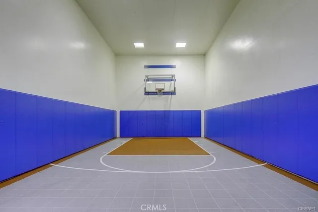 a room with gym equipment and a chandelier