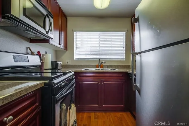 a kitchen with stainless steel appliances granite countertop a stove and a refrigerator