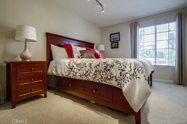 a bedroom with a bed and a window