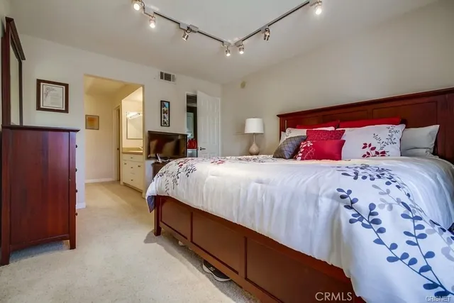 a bed room with a bed and a tv