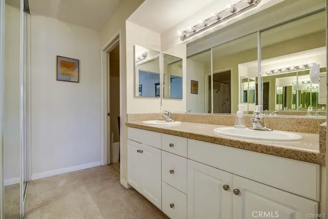 a bathroom with a granite countertop sink mirror and
