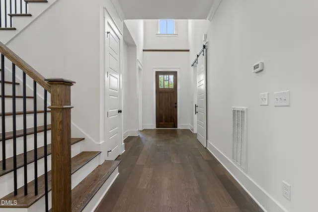 a front view of a house with a window and a rug