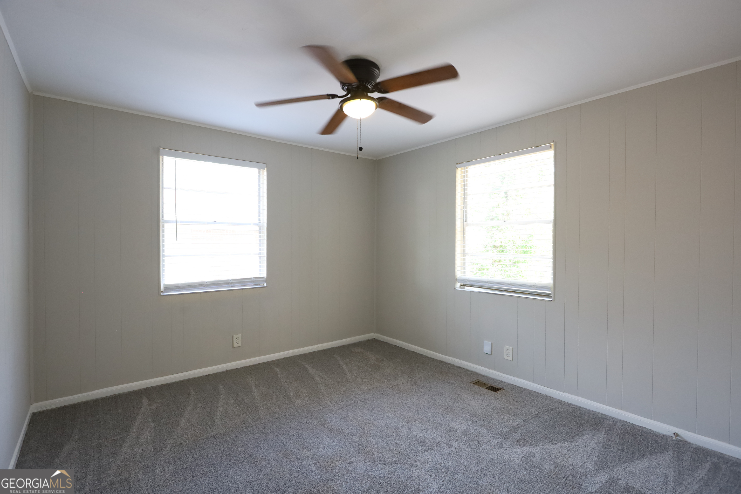 2096 Dellwood Place Decatur, GA 30032 - Photo 5 of 8 an empty room with ceiling fan and window