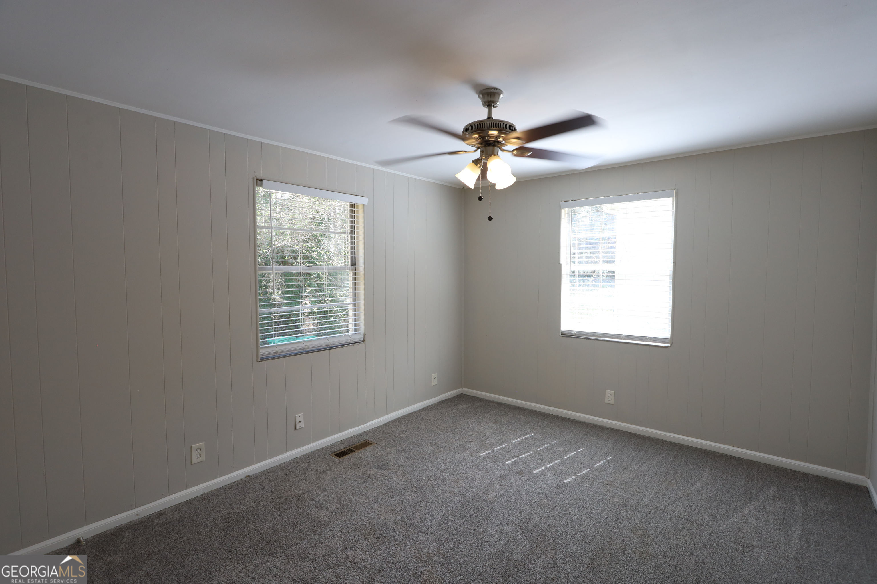 2096 Dellwood Place Decatur, GA 30032 - Photo 6 of 8 an empty room with a window and a fan