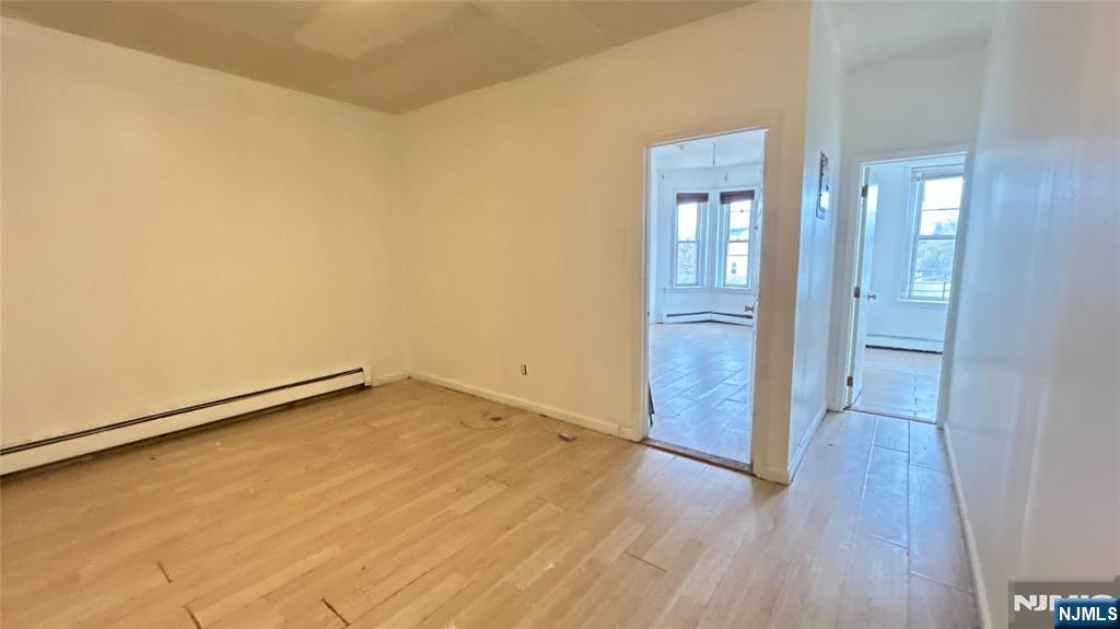 239 South 8th Street, Unit 3 Newark, NJ 07103 - Photo 3 of 7 wooden floor in an empty room