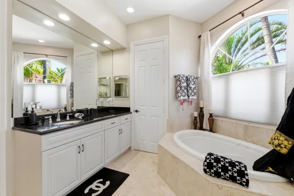 a view of a swimming pool with a patio and a garden