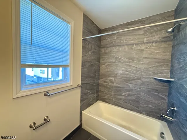 a bathroom with a bathtub and shower
