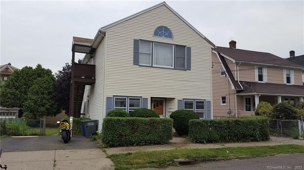 97 Alfred Street Bridgeport, CT 06605 - Photo 1 of 1 a front view of a house with a yard
