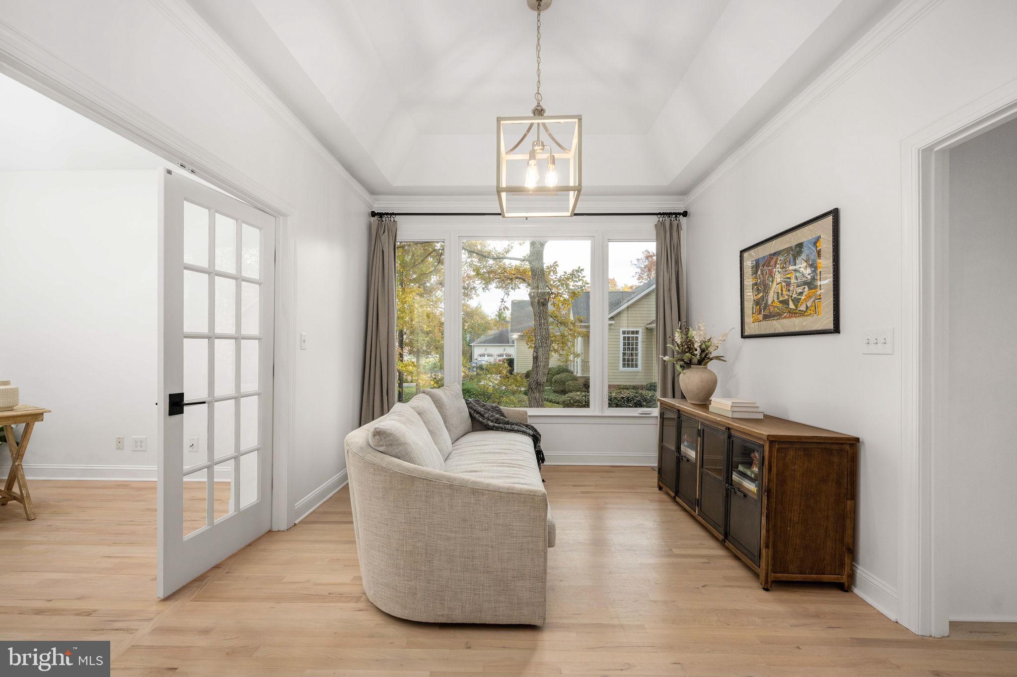 10816 Chatham Ridge Way Spotsylvania, VA 22551 - Photo 12 of 101 a living room with furniture a chandelier and a large window