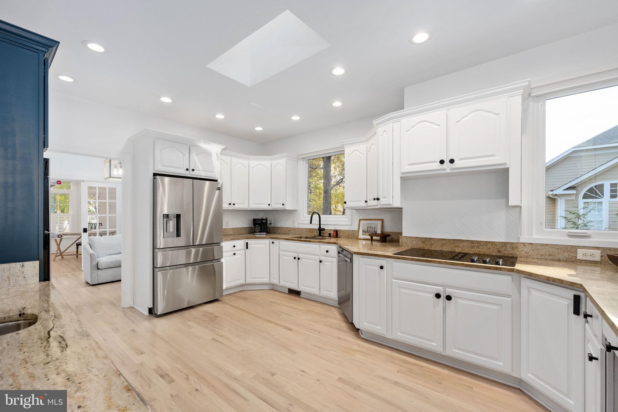 10816 Chatham Ridge Way Spotsylvania, VA 22551 - Photo 19 of 101 a kitchen with white cabinets and stainless steel appliances