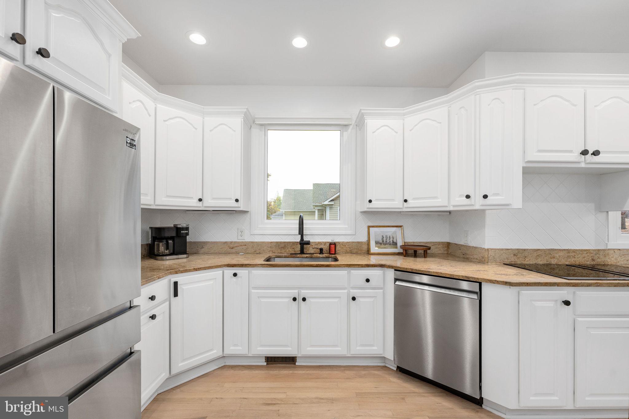 10816 Chatham Ridge Way Spotsylvania, VA 22551 - Photo 23 of 101 a kitchen with white cabinets sink and refrigerator