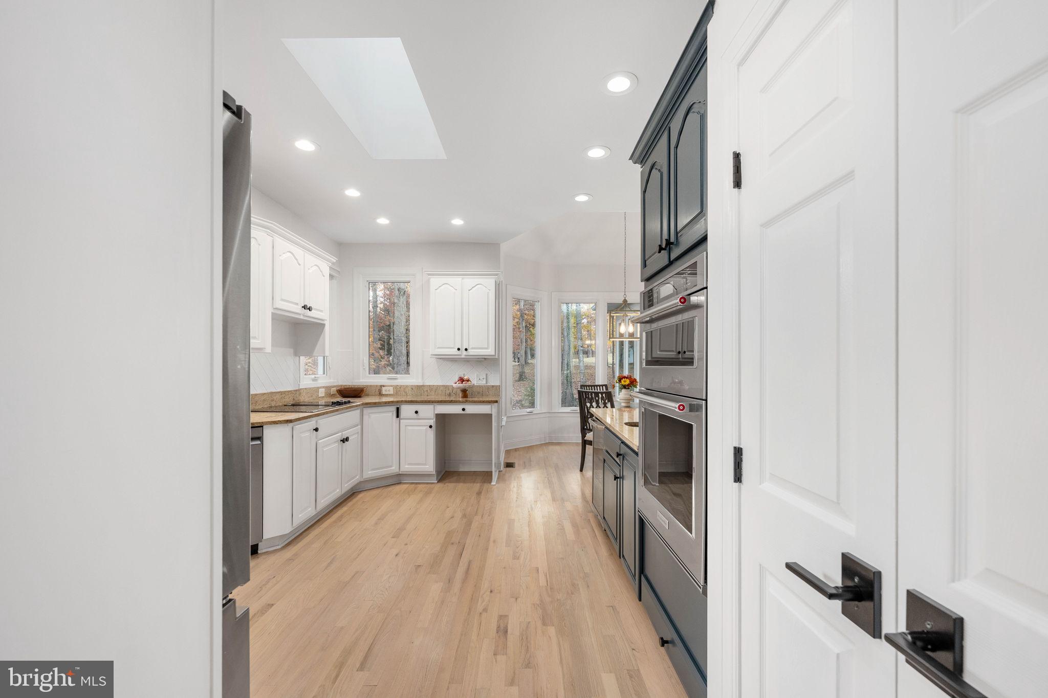 10816 Chatham Ridge Way Spotsylvania, VA 22551 - Photo 24 of 101 a kitchen with stainless steel appliances a refrigerator and a stove top oven