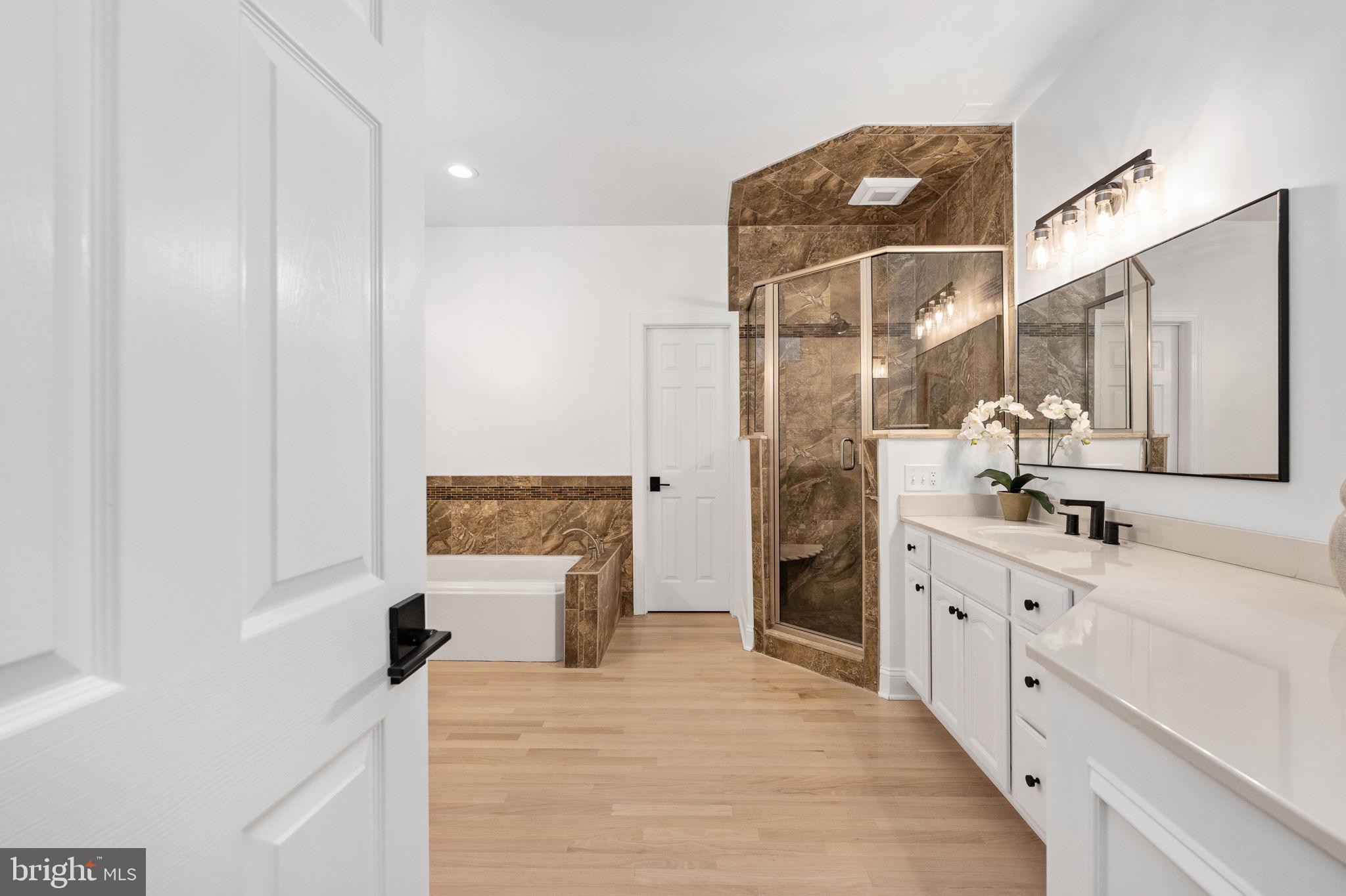 10816 Chatham Ridge Way Spotsylvania, VA 22551 - Photo 32 of 101 a spacious bathroom with a double vanity sink a mirror and a shower