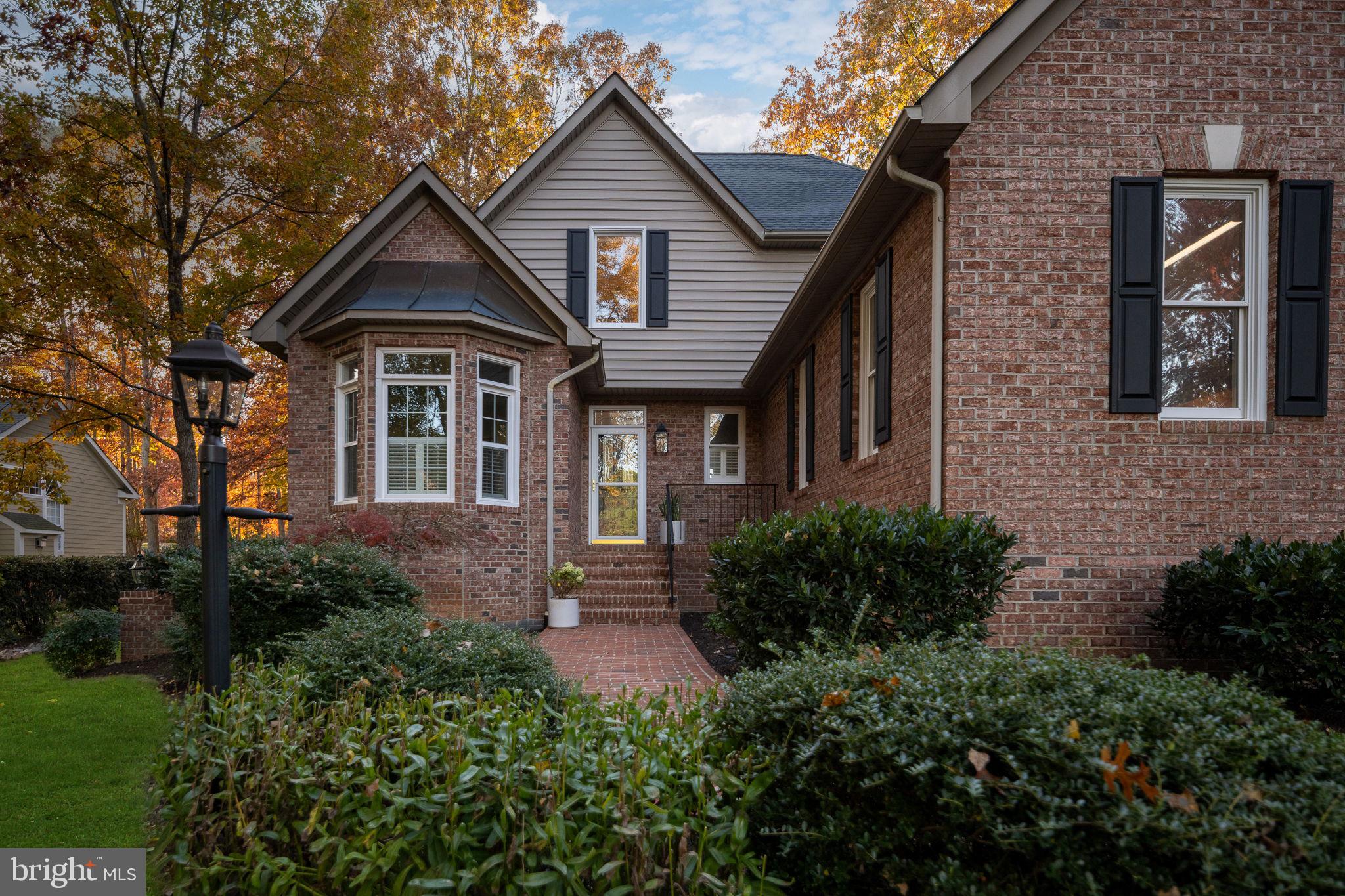 10816 Chatham Ridge Way Spotsylvania, VA 22551 - Photo 77 of 101 a front view of a house with garden