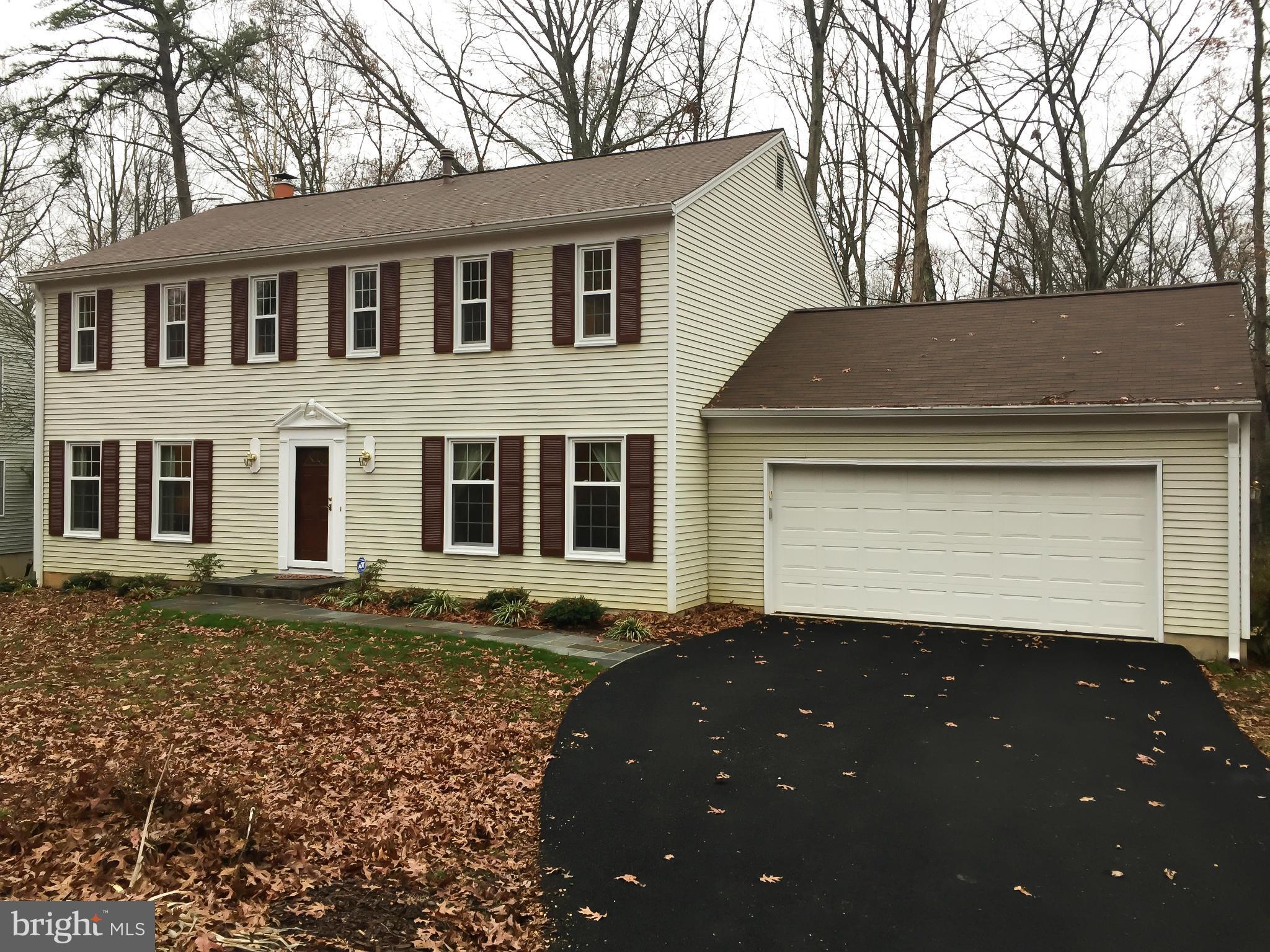 11423 Running Cedar Road Reston, VA 20191 - Photo 1 of 28 a front view of a house with a garden
