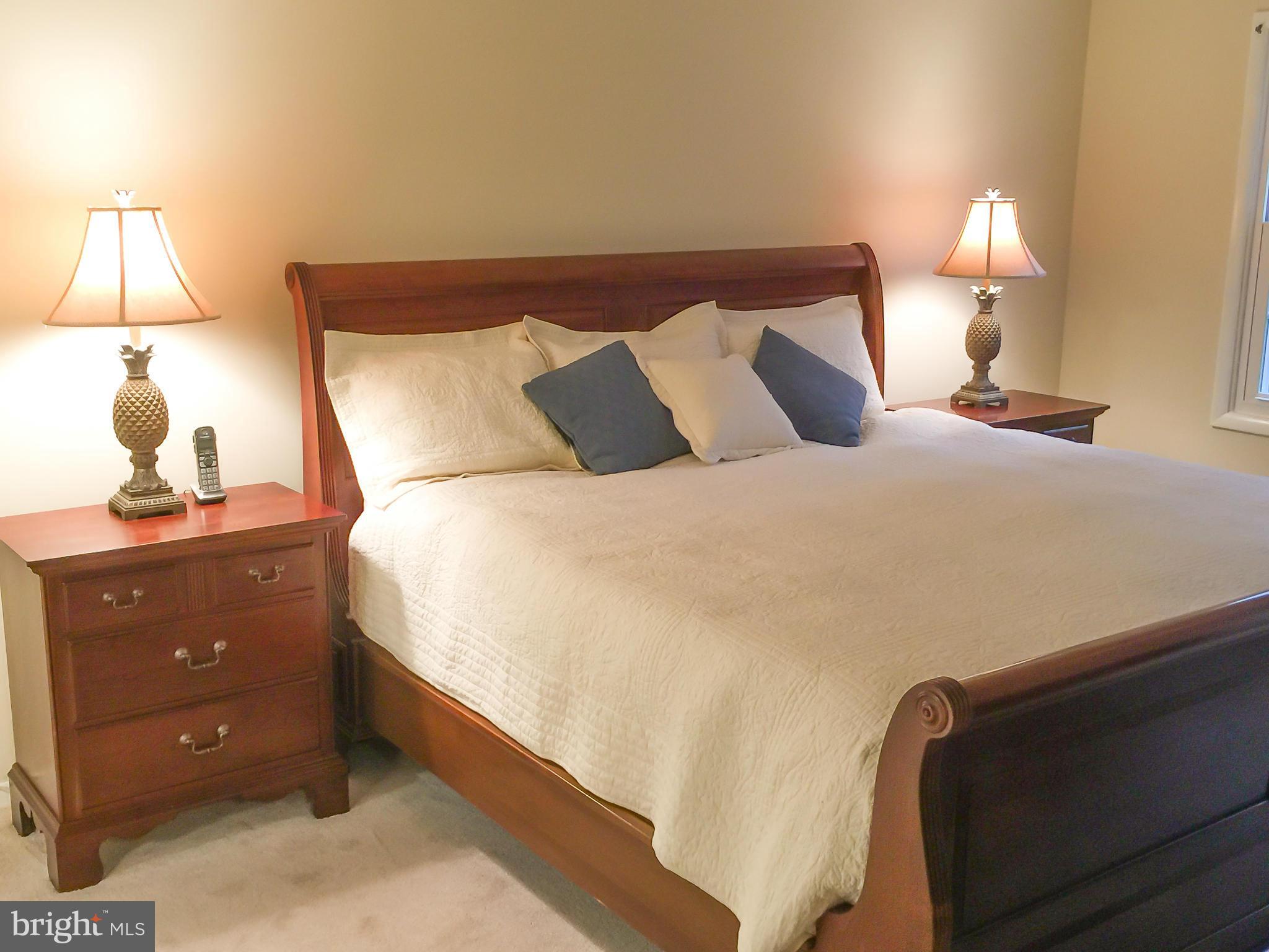 11423 Running Cedar Road Reston, VA 20191 - Photo 16 of 28 a large bed sitting in a bedroom next to a lamp