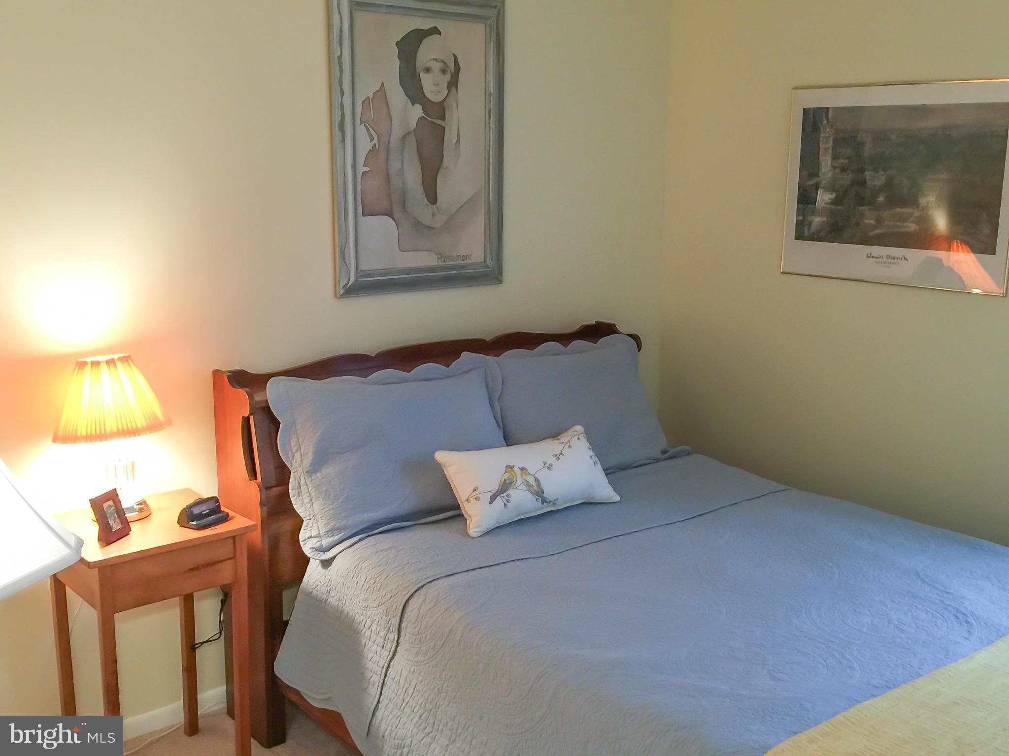 11423 Running Cedar Road Reston, VA 20191 - Photo 21 of 28 a bedroom with a bed and a painting on the wall