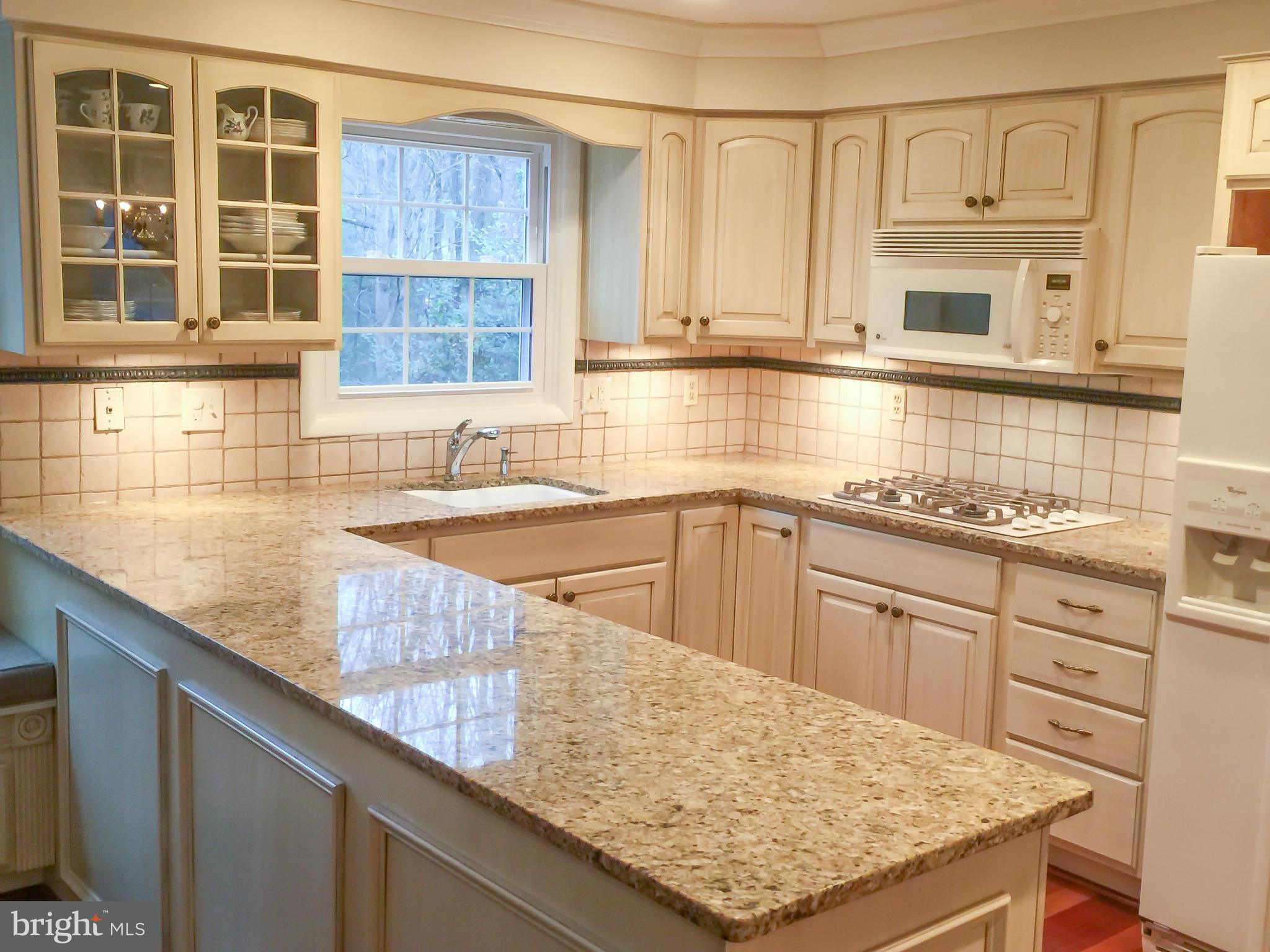 11423 Running Cedar Road Reston, VA 20191 - Photo 6 of 28 a kitchen with stainless steel appliances granite countertop a sink stove and cabinets