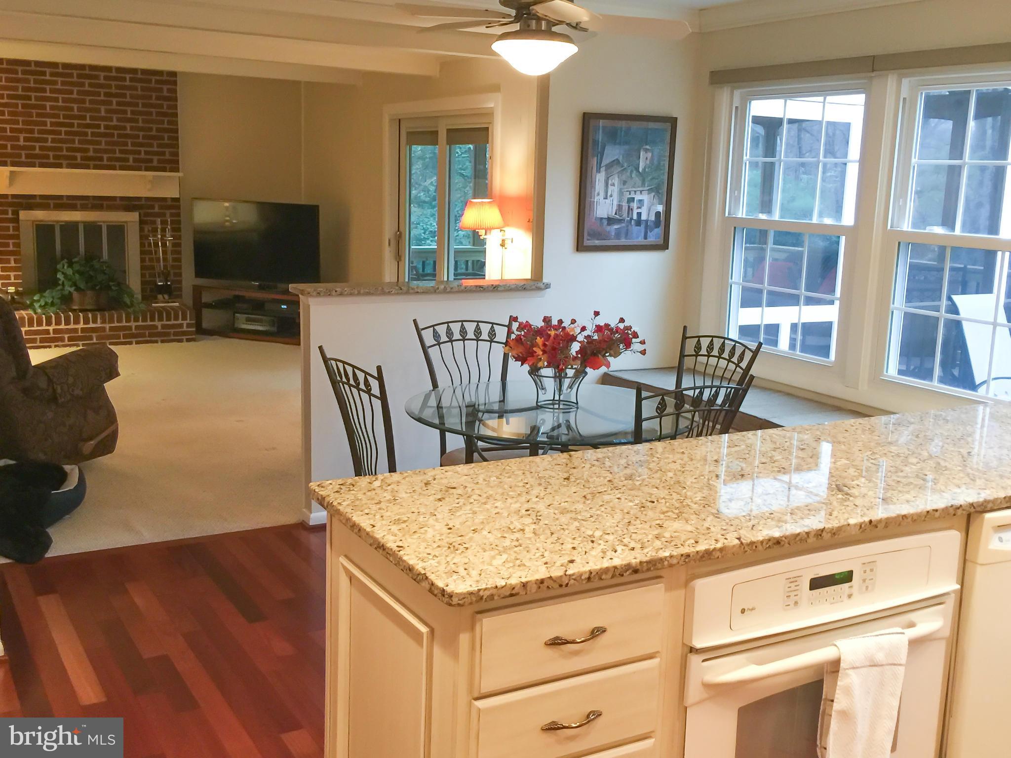 11423 Running Cedar Road Reston, VA 20191 - Photo 8 of 28 a kitchen with a stove and a wooden floor