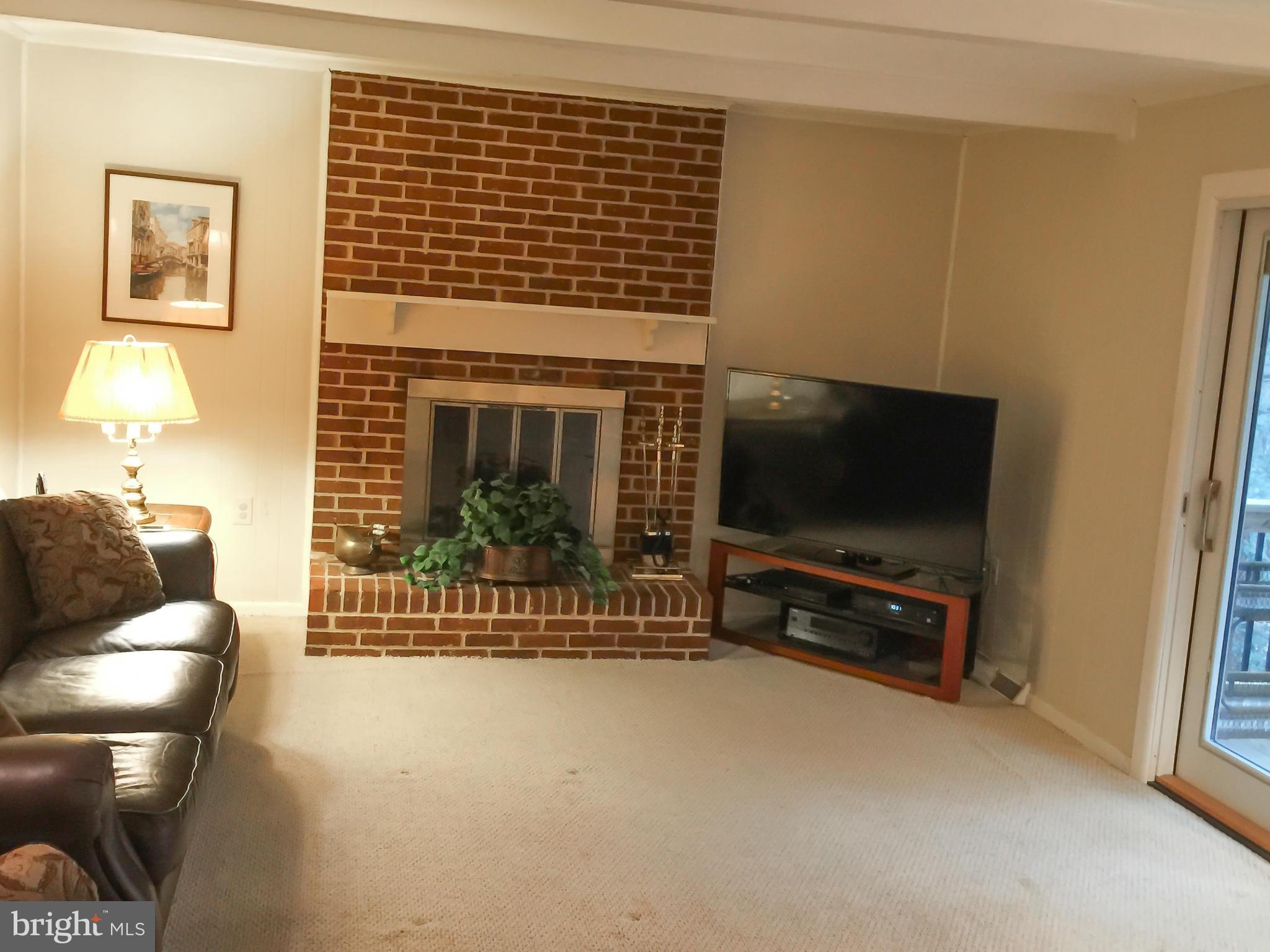 11423 Running Cedar Road Reston, VA 20191 - Photo 10 of 28 a living room with furniture and a flat screen tv